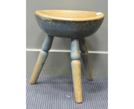 A blue painted three legged milking stool