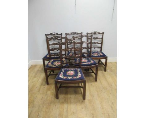 A set of eight 20th century mahogany dining chairs with pierced ladder backs including 2 with arms, upholsterd in gros- point