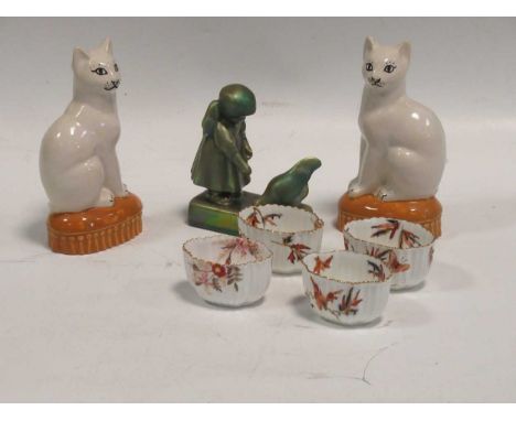 A Zsolnay lustre glazed model of a young girl feeding a chicken, together with a pair of Staffordshire style cats and four sm