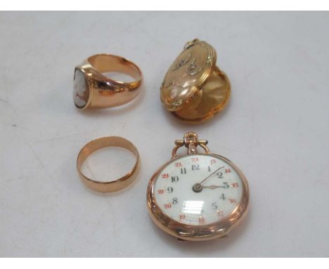 A cameo ring tested as 18ct gold, a wedding ring tested as 18ct gold, a locket tested as 18ct gold and a small continental op