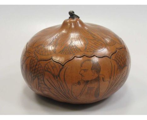 A gourd carved with a head portrait of Napoleon amongst flowers and leaves, with cover
