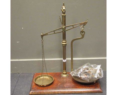 Two early 20th century brass sets of scales on mahogany plinths, largest 72cm high