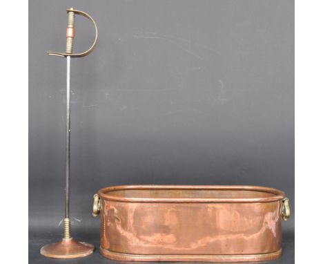 An early 20th century copper planter having a lipped edge, carry handles to each end raised on a plith base Measures 13cm x 4
