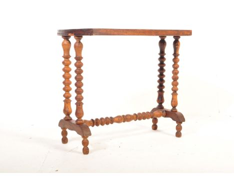 An early 20th century Edwardian mahogany side occasional table having a central inlaid shell motif to the table raised on on 