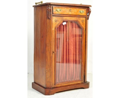 A late 19th century Victorian marquetry and line inlaid pedestal music cabinet. Raised on a plinth base with central glazed c