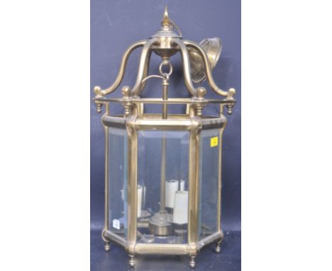 A large 20th century wrought metal porch lantern light shade of octagonal form having ceiling fixture to top and bevelled gla