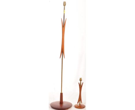 A retro vintage mid 20th century teak and metal floor standing standard lamp having a central atomic teak feature raised on a