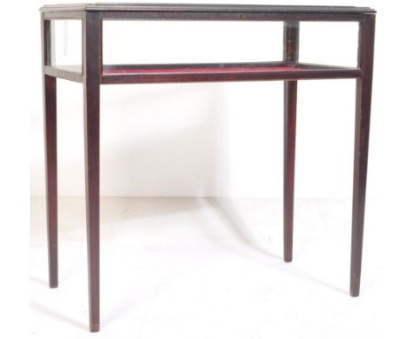 An Edwardian mahogany bijouterie display cabinet table.&nbsp; Raised on squared legs with a hinged top glass display cabinet 