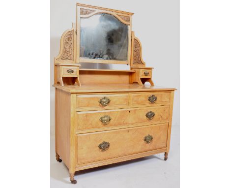 An early 20th century Edwardian satin walnut dressing table chest . The chest having a central mirror with foliate carving fl