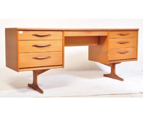 A mid century / retro 20th century teak wood writing table desk - dressing table. Raised on angular supports having a central