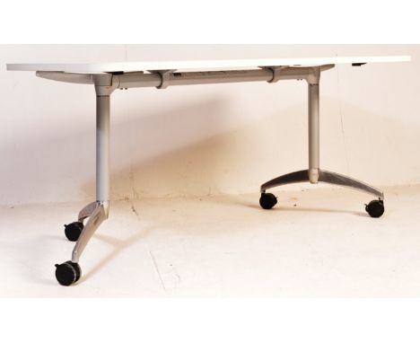 A Senator S21 Flight table, conference table or work desk. The table with aluminium finish legs on plastic castors that folds
