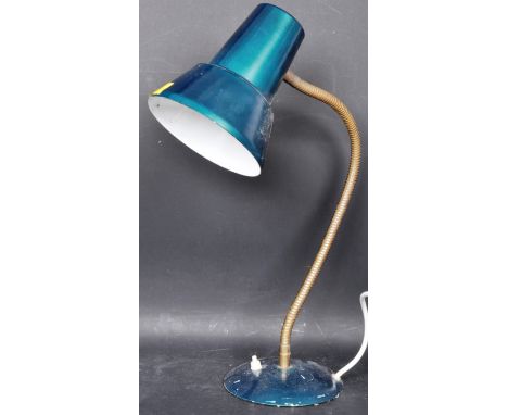 A retro vintage industrial mid 20th century desktop lamp having conical light shade with gilt flexi support raised on a circu