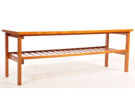 A mid 20th century circa 1960s teak wood occasional coffee table having a rectangular top raised on tapering supports united 