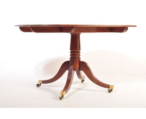 A 19th century Regency George III large flame mahogany tilt top loo / dining table. The dining table having a flame mahogany 