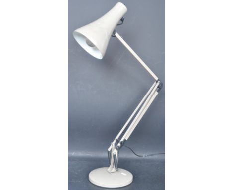 A retro vintage mid 20th century Herbert Terry style anglepoise lamp having a conical shade, three arm support raised on a ci