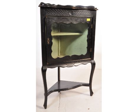 
A late 19th century Victorian Aesthetic Movement ebonised corner cabinet. The cabinet having a single glazed display cabinet