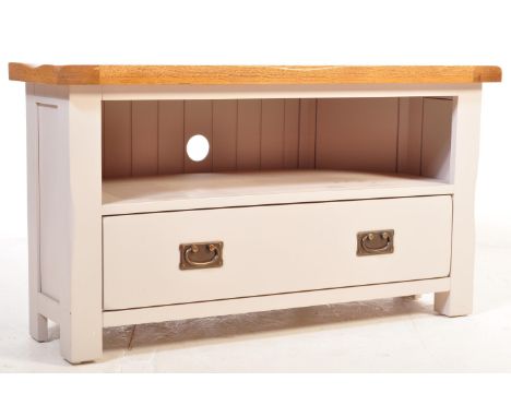 A contemporary Oak Furniture Land St Ives range Television TV stand having a flared top with recess shelf below over a single