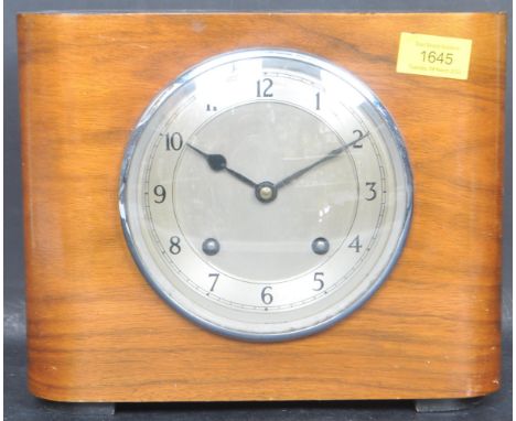 An early 20tyh century circa. 1930s Garrard mantle clock with a domed walnut case with silvered dial and black enamel numeral