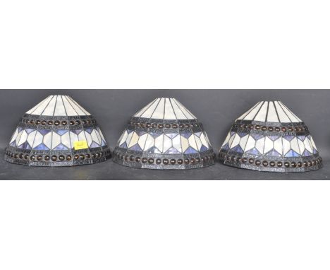 A collection of three Art Deco Tiffany style wall light shades. Each having mottles glass panels held together with lead bond