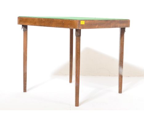 A vintage 20th century, circa 1920's Vono oak folding games table having a baize table top of square form over levered tapere