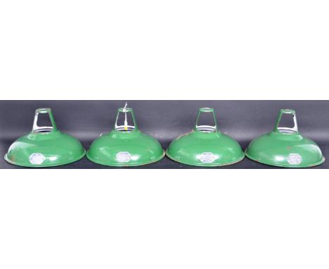 A collection of four retro vintage Coolicon green enamel UFO light shades having a flared edge with white interior. Makers ma