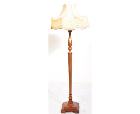 An Edwardian solid mahogany standard lamp and shade. The mahogany floor lamp being raised over a stepped plinth and being of 