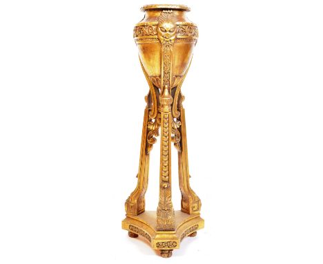 A 20th century Victorian / Egyptian Revival gilt planter / jardinière on stand having a flared top over a tapering urn adorne