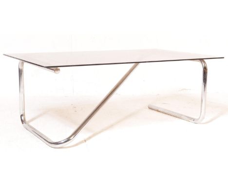 A retro vintage mid 20th century chrome and glass coffee table of rectangular form having a smoked glass table top raised on 