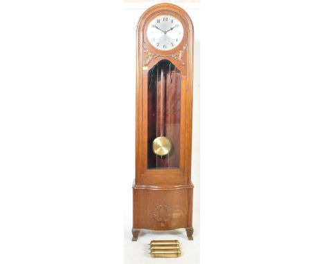 A 1930's Hamburg America Clock co longcase Westminster chiming clock. The silvered dial marked HAC with Arabic numeral chapte