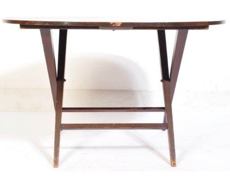 A 19th century Victorian mahogany coaching table, with folding circular top raised on X-frame under structure. Makers trade l
