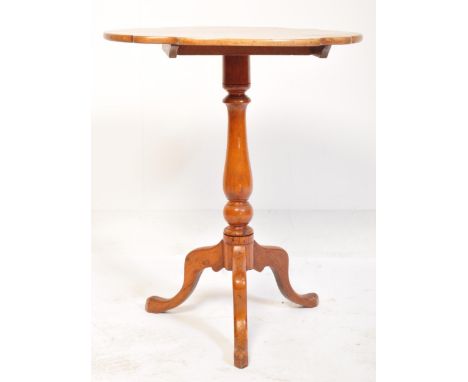 A 19th century Victorian mahogany tilt top pedestal wine table. The table being raised on splayed legs with turned column hav
