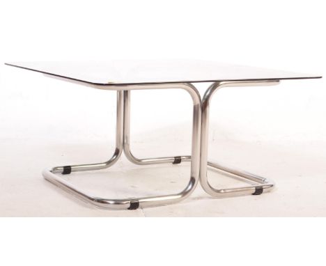 A retro mid 20th century coffee / occasional table having a smoked glass table top over a cantilever chrome frame. Measures 3