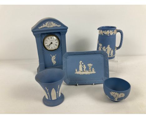 5 items of Wedgwood blue &amp; white jasper ware. To include: 9" Millennium mantel clock, 5" jug with rope design handle and 