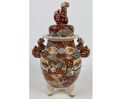 A vintage Japanese satsuma wear ceramic Koro with Foo dog handles and finial to lid. Painted figure decoration to font and ba