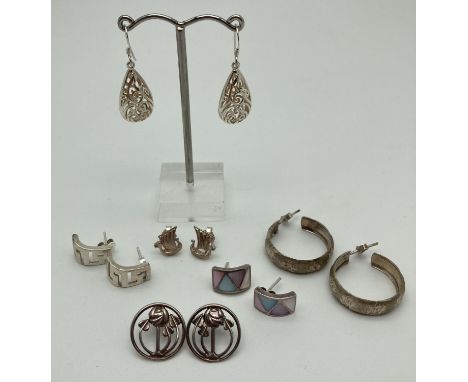 6 pairs of silver and white metal earrings in both stud and drop style for pierced ears. To include vintage style hoops, colo