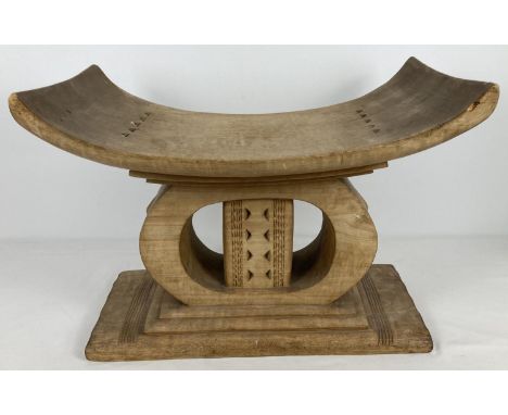 A vintage light wood African Ashanti "Golden stool" with curved seat and carved detail. Vendor advises item was bought back f