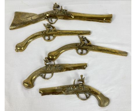 A collection of 5 vintage brass wall hanging gun ornaments. Largest approx. 46cm long. 