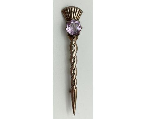 A vintage silver brooch with Celtic twist stem and thistle detail to end. Set with a round cut Rose De France amethyst. Stone