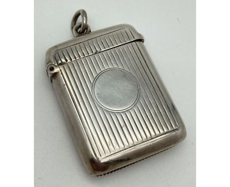 A Victorian silver vesta case with channeled detail front &amp; back and central circular blank cartouche. Hallmarked for Bir