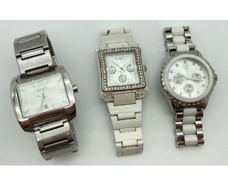 3 wristwatches by Next. All with stainless steel bracelet straps. A square face with silver tone hour markers and hands, a ro