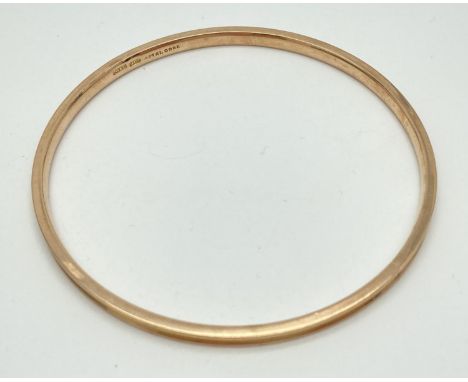 A large 9ct gold metal core bangle. Markers initials and "9ct Gold Metal Core" marked to inside. Shows signs of repair or alt