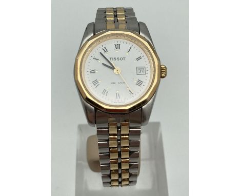 A ladies two tone stainless steel bracelet strap wrist watch by Tissot. Roman numeral hour markers, seconds hand and date fun