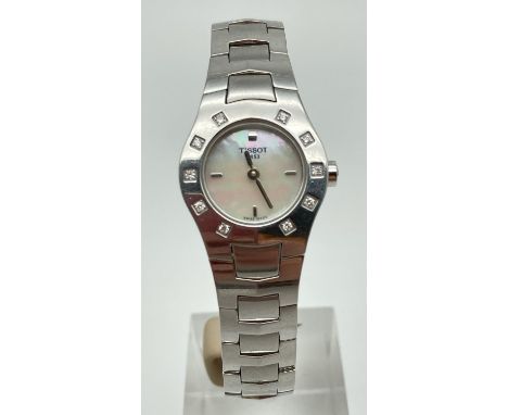 A ladies silver tone bracelet strap wrist watch by Tissot. Crystal set case with mother of pearl face, silver quarter hour ma