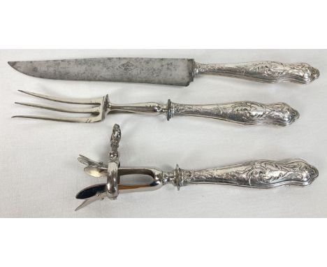 A Victorian white metal handled carving set to include a leg joint holder. Named to blade of knife C.P.&amp; Cie, Paris. 