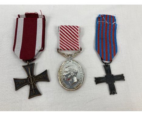 3 military medals. A Modern copy of the Polish Cross Of Valour, a replica George VI Air Force Medal and a Post War Monte Cass