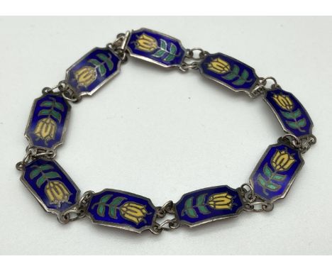 A vintage Siam silver 9 panel enamel set bracelet with yellow flower decoration. Push clasp with "Siam Sterling" marked to ba