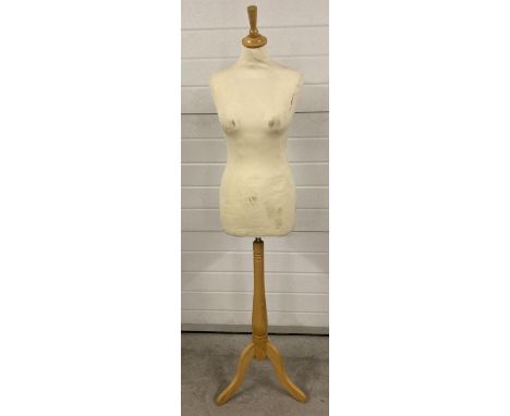 A full size clothes mannequin with tripod light wooden stand. Adjustable height. 