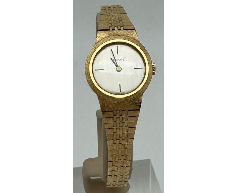 A vintage ladies 10 Microns gold bracelet style wristwatch by Tissot. Brushed silver tone face with black quarter hour marker