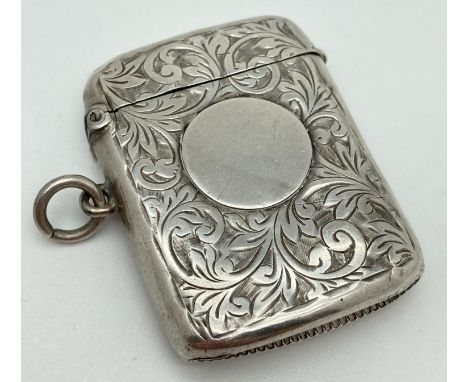 A large Edwardian silver vesta case with engraved scroll &amp; foliate design to both sides. Front features a central circula