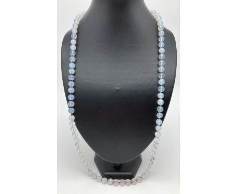 A vintage knotted moonstone bead necklace with pierced work white metal clasp. Approx. 30 inches long. 